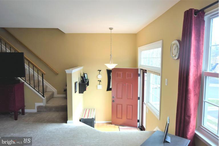 403 McDaniel Drive Purcellville, VA 20132 - Photo 3 of 13 a view of a hallway with windows and stairs