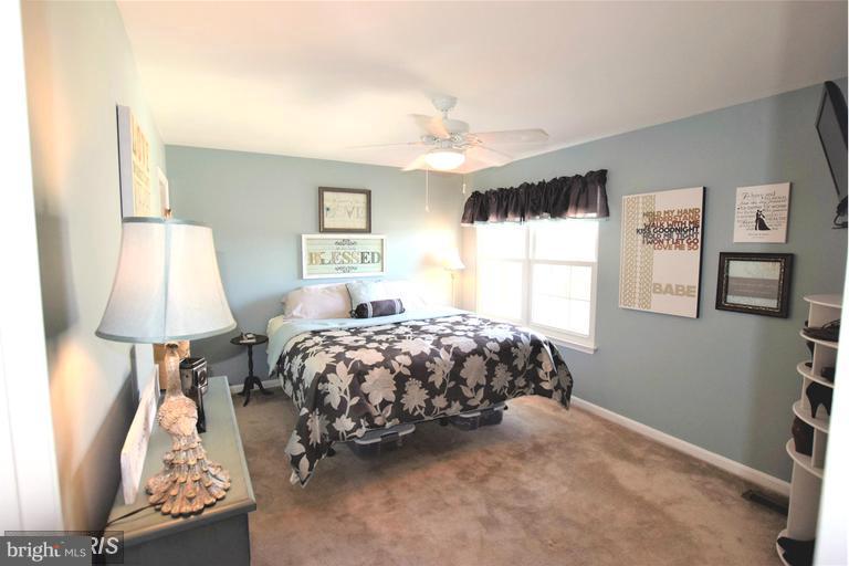 403 McDaniel Drive Purcellville, VA 20132 - Photo 6 of 13 a bedroom with a bed and a window
