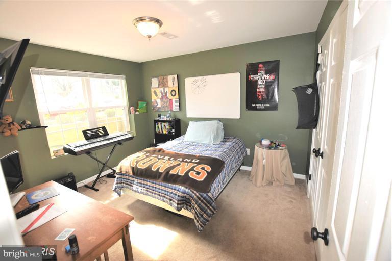 403 McDaniel Drive Purcellville, VA 20132 - Photo 10 of 13 a bedroom with a bed and a window