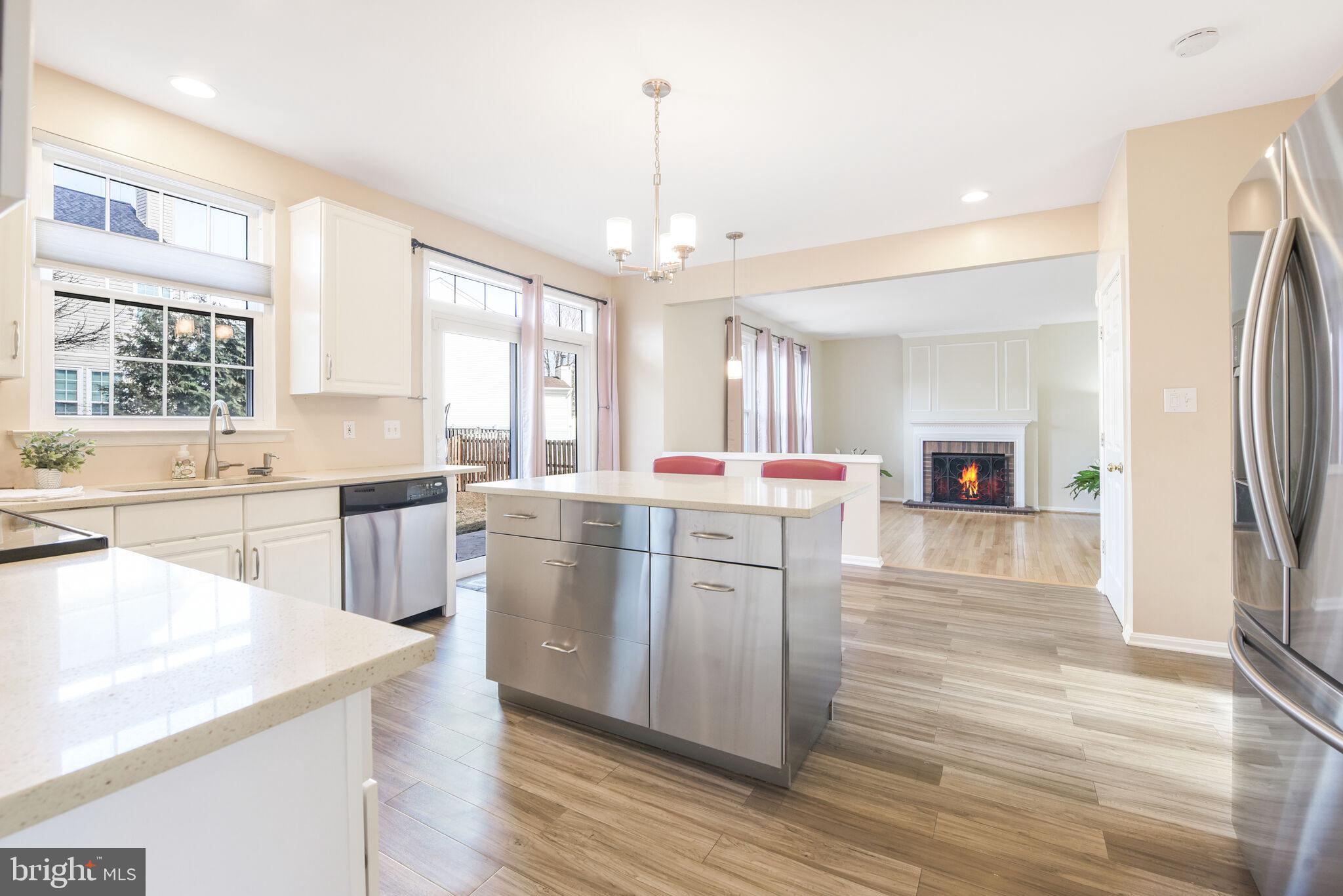 20907 Chippoaks Forest Circle Sterling, VA 20165 - Photo 14 of 71 a kitchen with a refrigerator a sink dishwasher with a dining table and chairs
