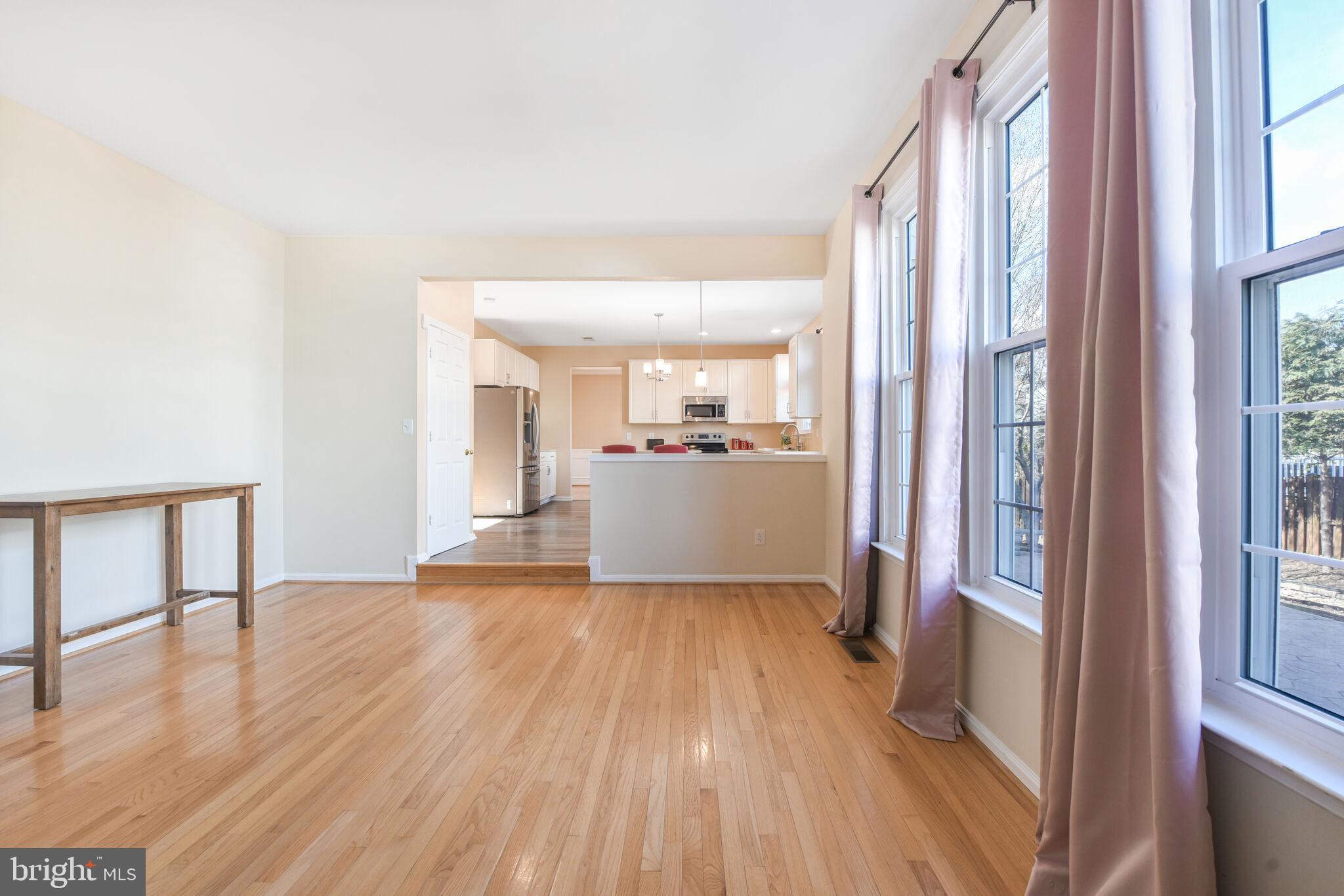 20907 Chippoaks Forest Circle Sterling, VA 20165 - Photo 16 of 71 a view of a kitchen with wooden floor and a window