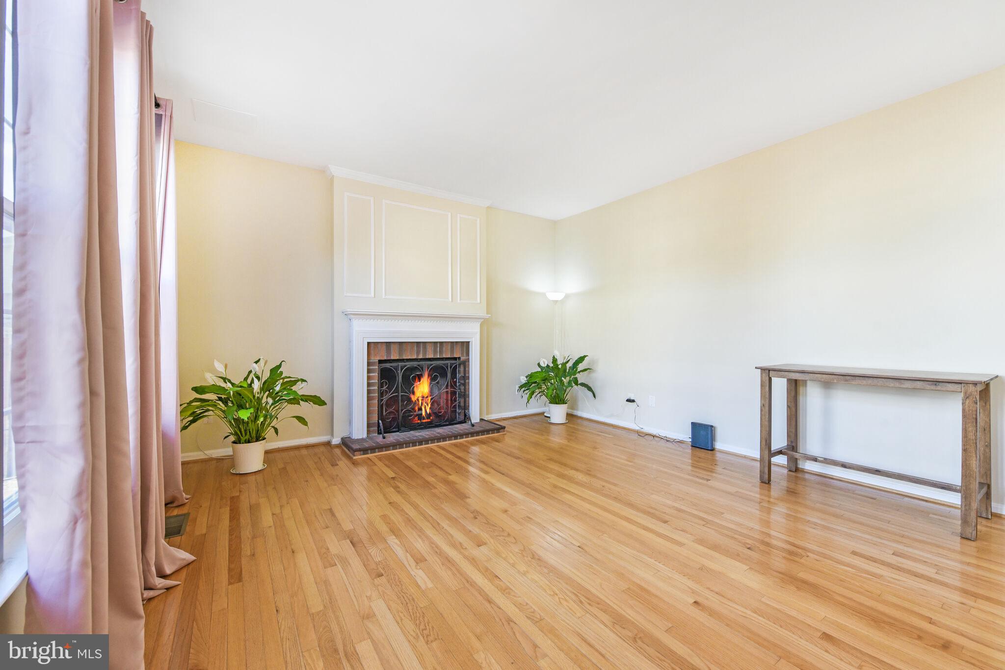 20907 Chippoaks Forest Circle Sterling, VA 20165 - Photo 17 of 71 a living room with a fireplace and wooden floor