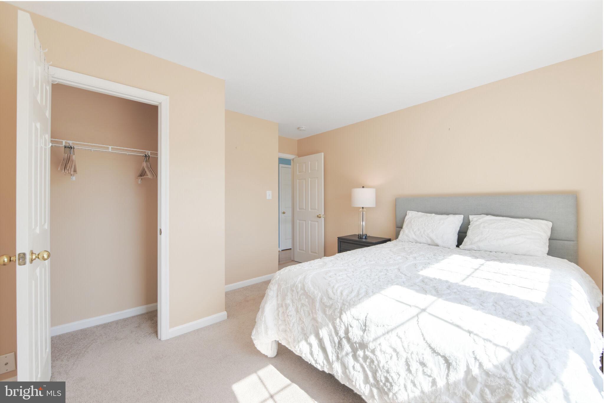 20907 Chippoaks Forest Circle Sterling, VA 20165 - Photo 23 of 71 a bedroom with a bed and a closet