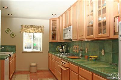 La Mancha Drive Sonoma, CA 95476 - Photo 5 of 9 a kitchen with stainless steel appliances granite countertop a sink a stove and a wooden cabinets