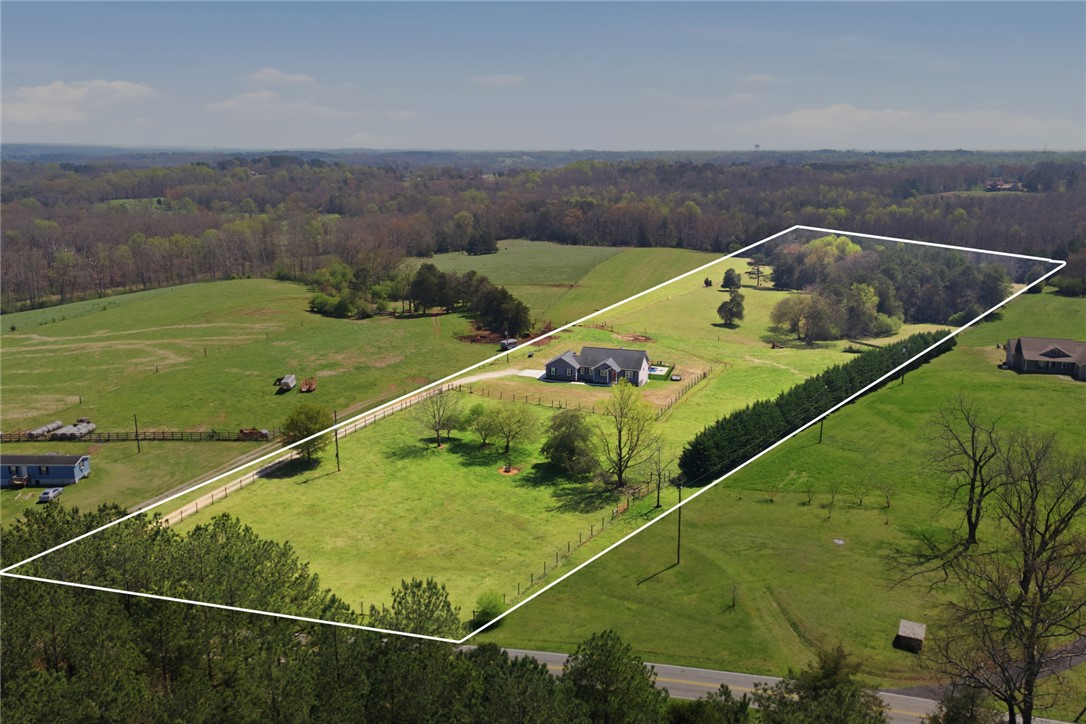 426 Oak Creek Road Seneca, SC 29678 - Photo 49 of 50 Expansive green acreage surrounds a welcoming home, offering a serene escape.