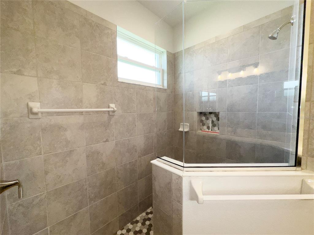3775 Manorwood Loop Parrish, FL 34219 - Photo 15 of 30 a bathroom with a bathtub and shower
