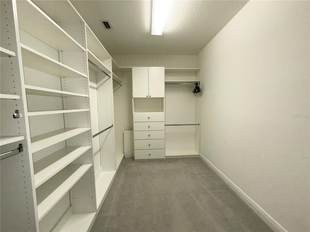 3775 Manorwood Loop Parrish, FL 34219 - Photo 18 of 30 a view of walk in closet with empty racks