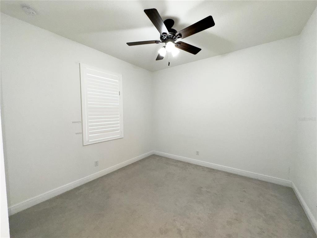 3775 Manorwood Loop Parrish, FL 34219 - Photo 22 of 30 an empty room with a window and a fan