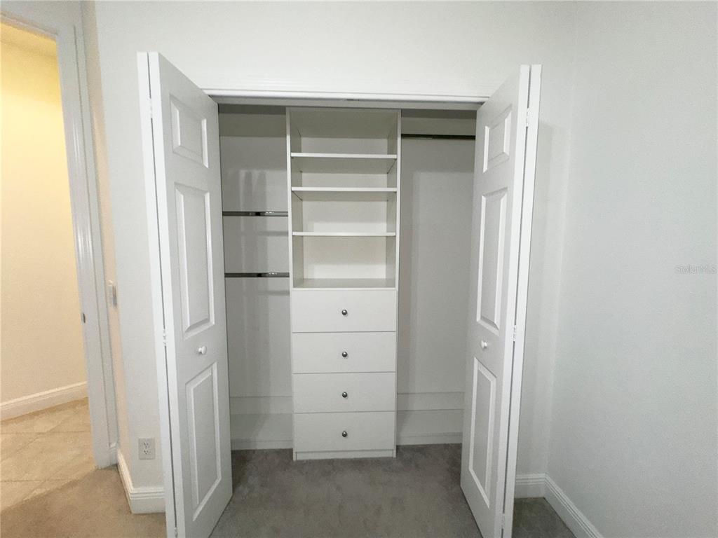 3775 Manorwood Loop Parrish, FL 34219 - Photo 23 of 30 a view of walk in closet with empty racks