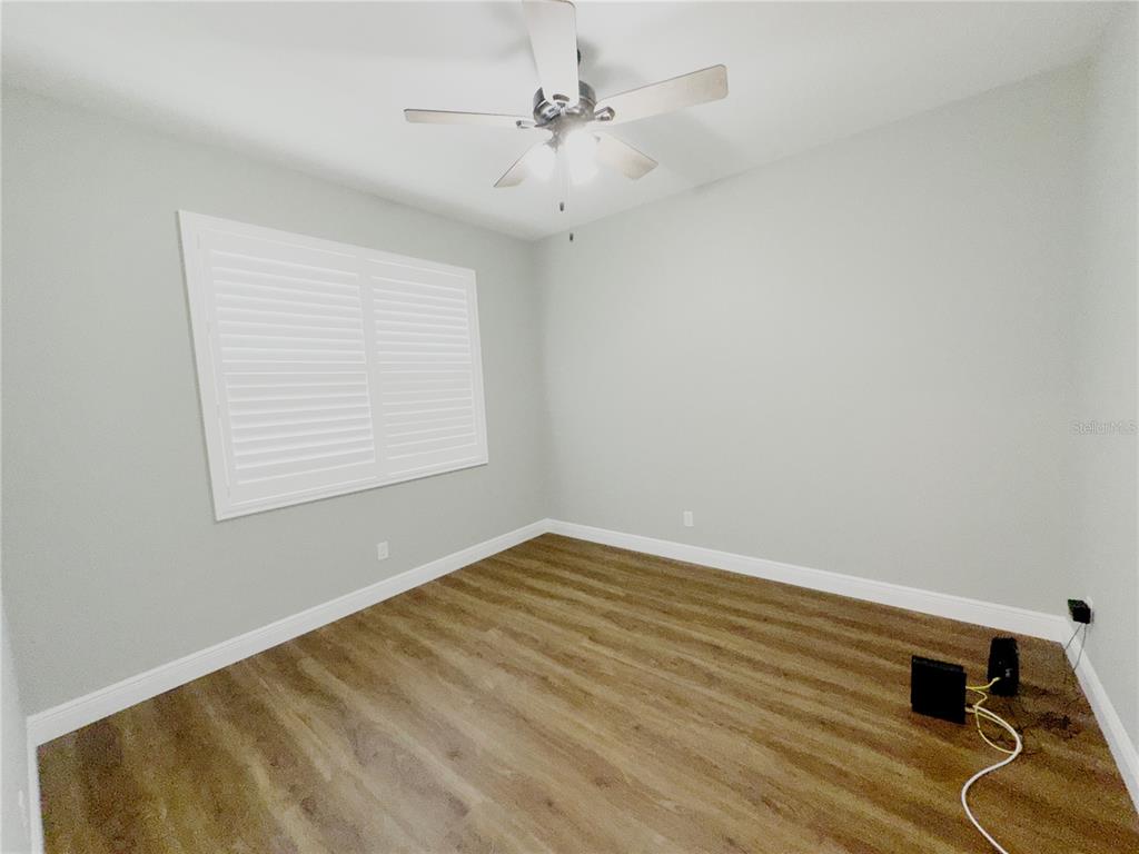 3775 Manorwood Loop Parrish, FL 34219 - Photo 25 of 30 wooden floor in an empty room with a window