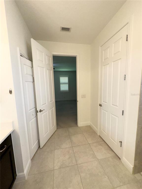 3775 Manorwood Loop Parrish, FL 34219 - Photo 26 of 30 a view of a hallway with wooden floor and closet area