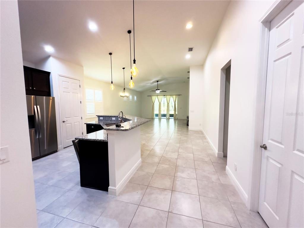 3775 Manorwood Loop Parrish, FL 34219 - Photo 9 of 30 a view of kitchen with stainless steel appliances kitchen island granite countertop a refrigerator a oven and a sink