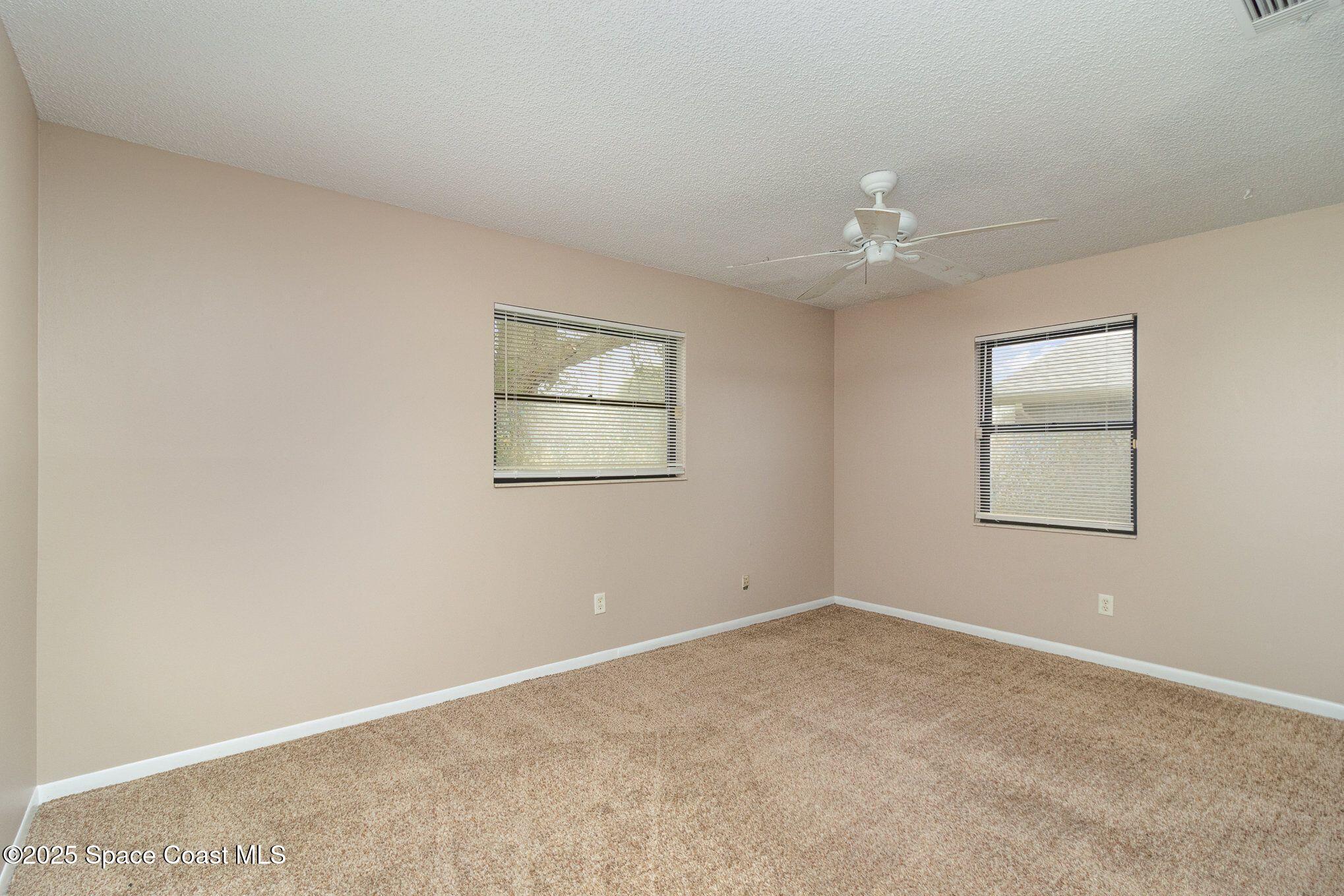 2863 Corbusier Drive Melbourne, FL 32935 - Photo 15 of 20 an empty room with windows