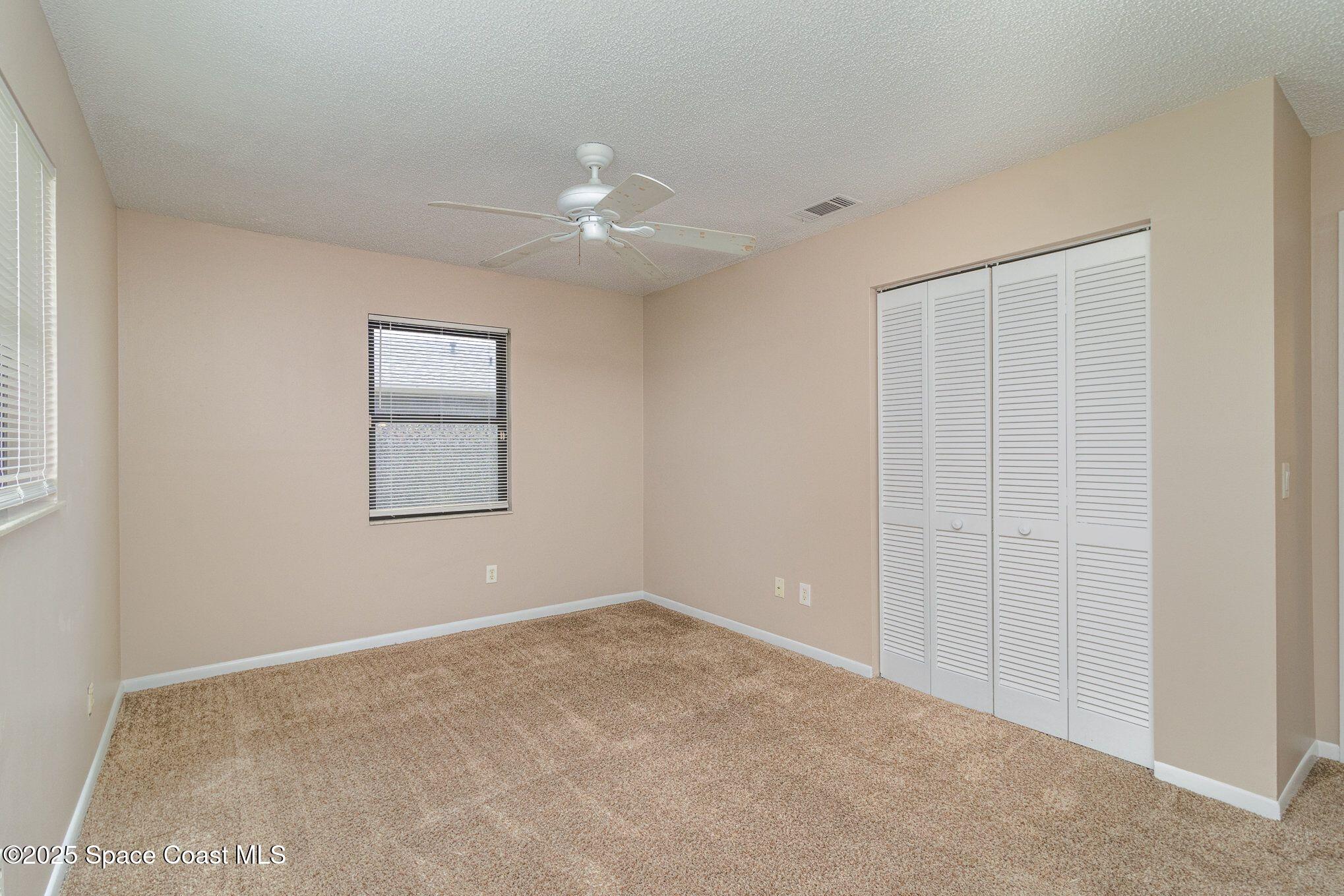 2863 Corbusier Drive Melbourne, FL 32935 - Photo 16 of 20 an empty room with windows and closet