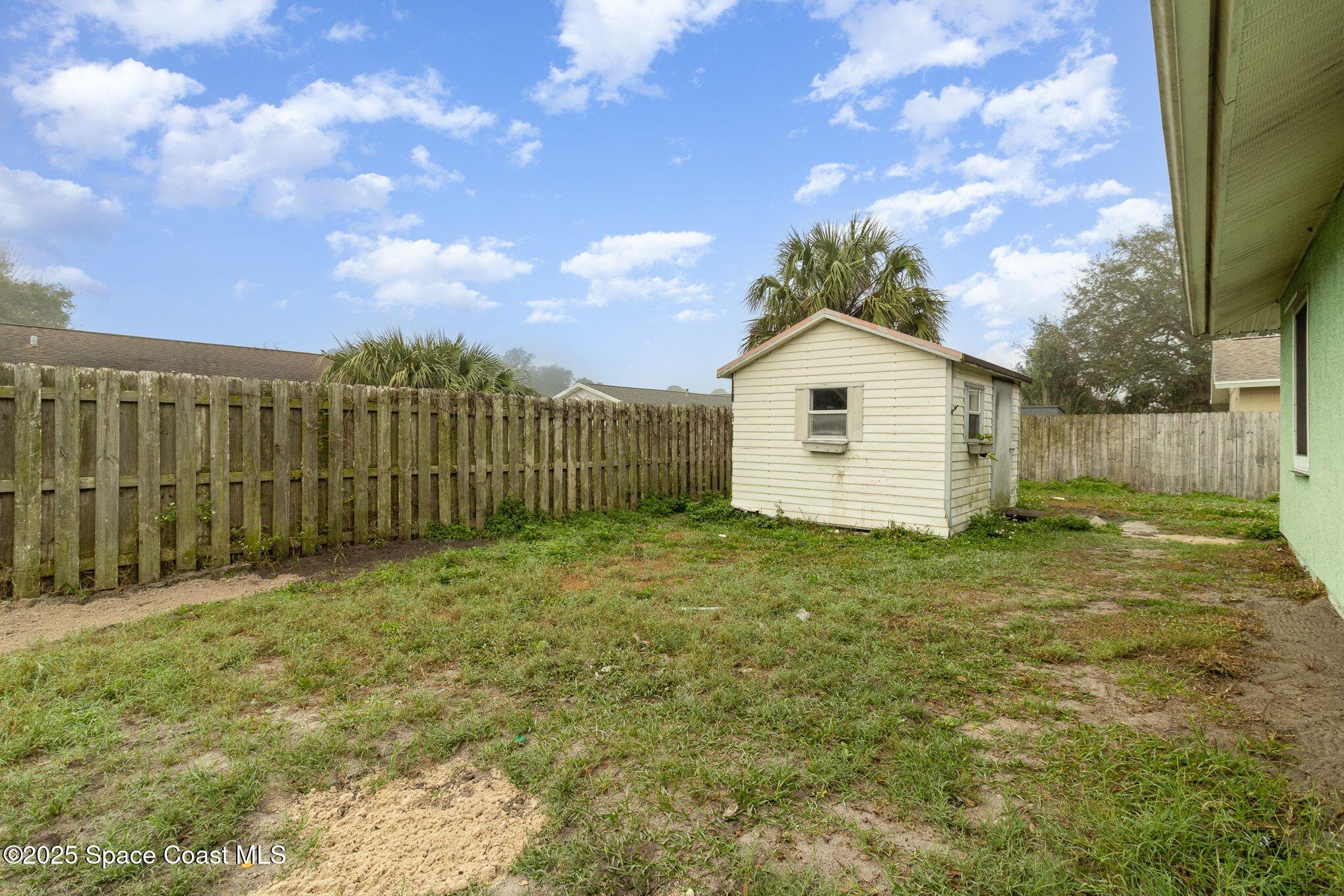 2863 Corbusier Drive Melbourne, FL 32935 - Photo 19 of 20 a bathroom with a sink and a yard