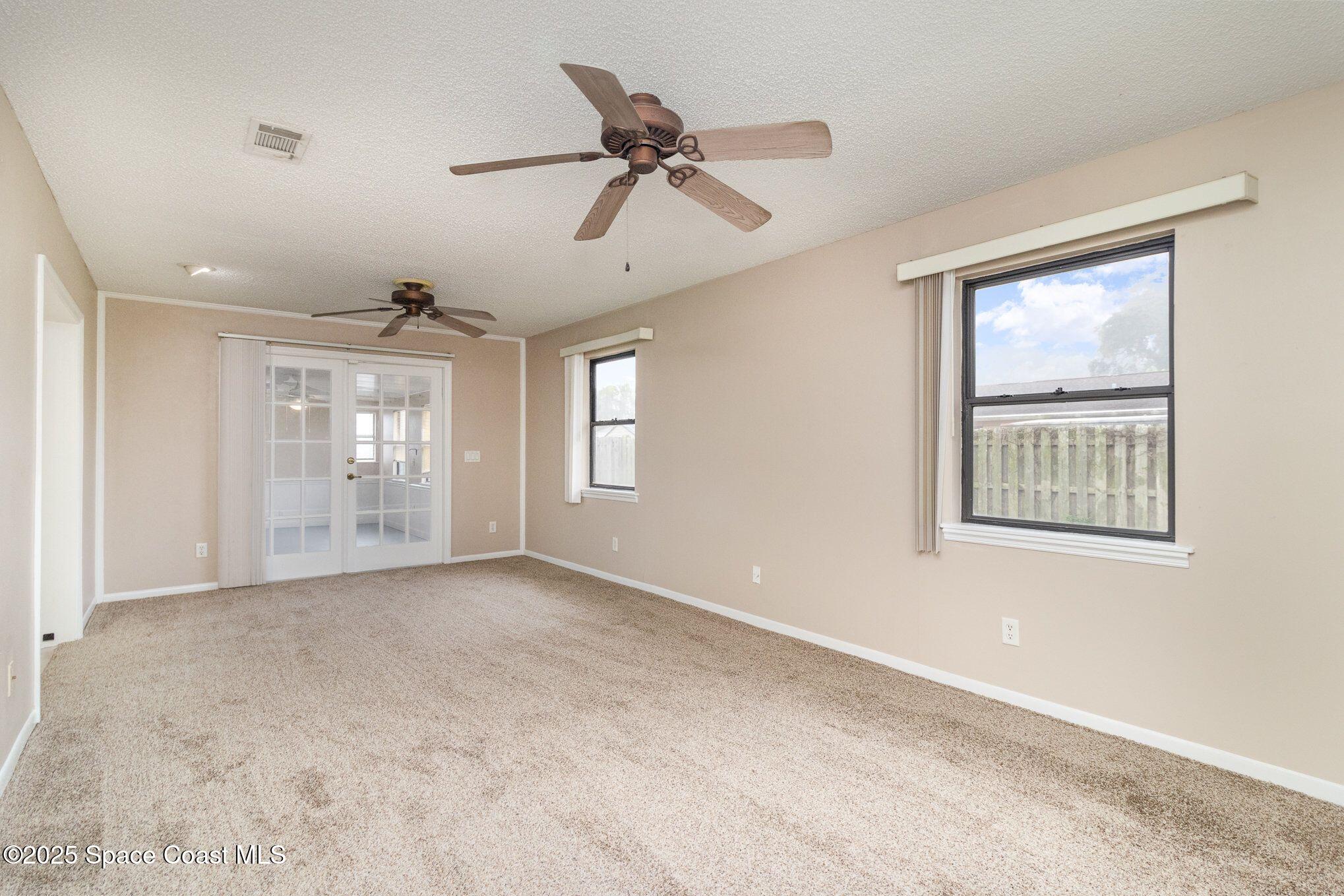 2863 Corbusier Drive Melbourne, FL 32935 - Photo 7 of 20 a view of an empty room with a window