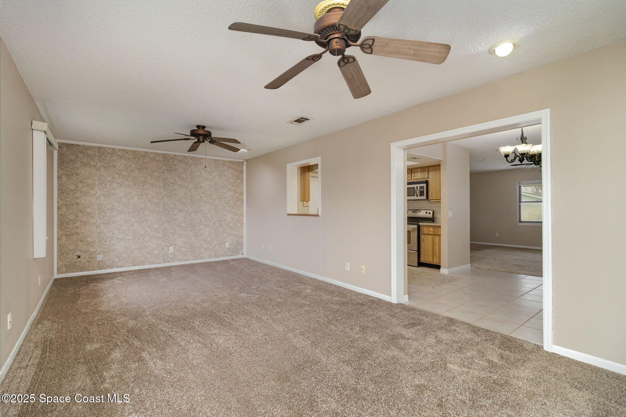 2863 Corbusier Drive Melbourne, FL 32935 - Photo 8 of 20 an empty room with closet and a ceiling fan