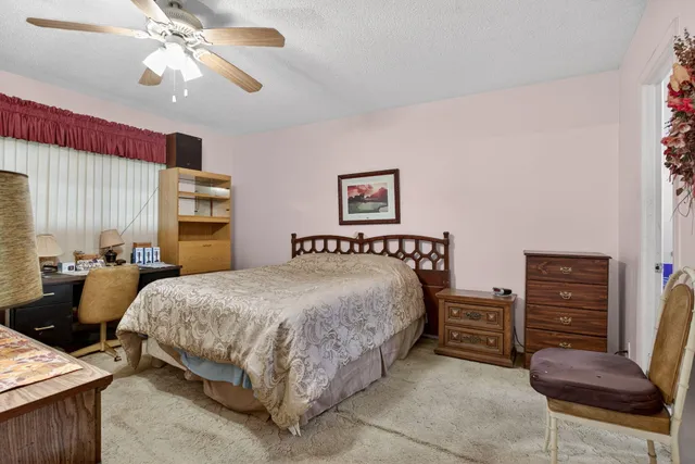 a large bed sitting in a bedroom next to a window