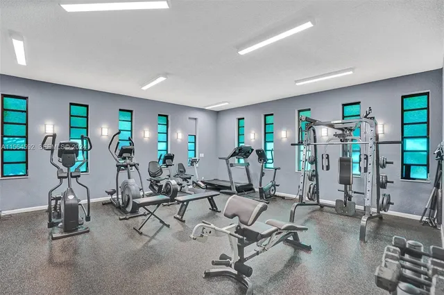 a view of a patio with table and chairs potted plants and large tree