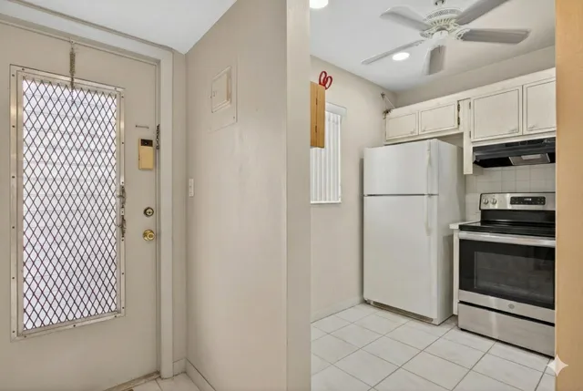 a kitchen with stainless steel appliances a refrigerator and a microwave