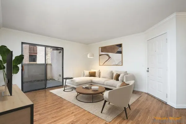 a view of a small space with wooden floor and a ceiling fan