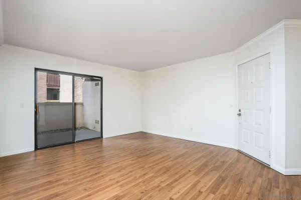 a view of a kitchen with wooden floor and a sink