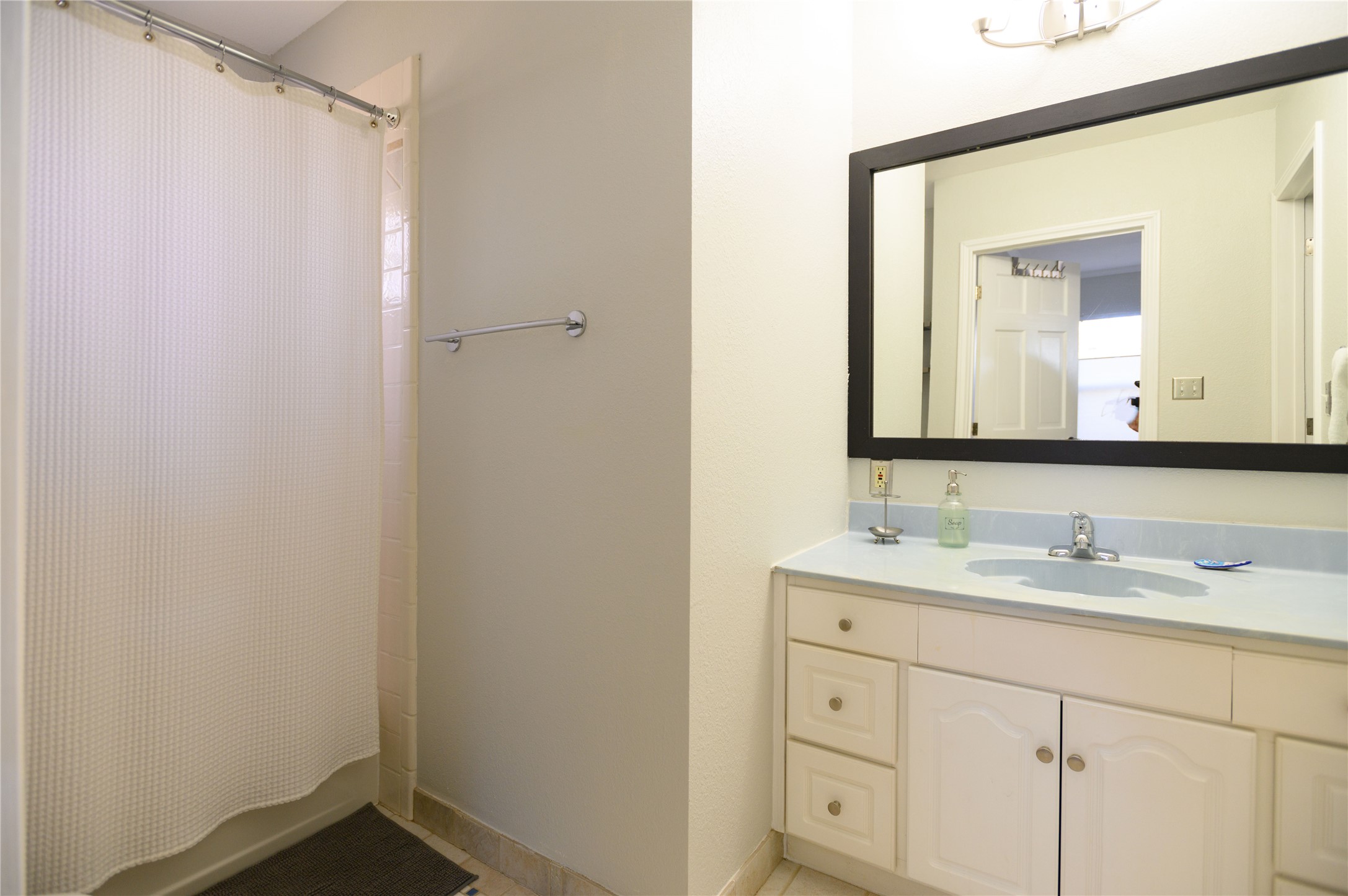 4902 Pecan Springs Road Austin, TX 78723 - Photo 40 of 40 a bathroom with a double vanity sink and mirror