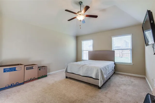 a spacious bedroom with a bed and window