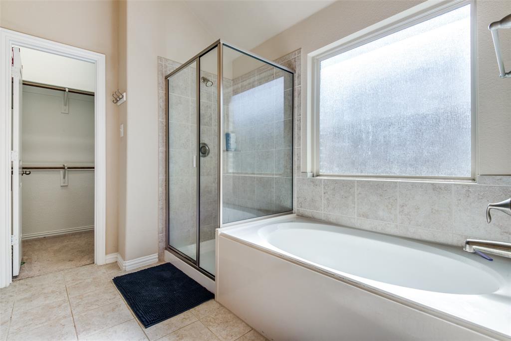 16621 Toledo Bend Court Prosper, TX 75078 - Photo 18 of 25 a bathroom with a bathtub and a shower
