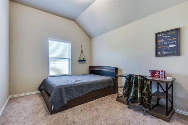 a bedroom with a bed a desk and chair