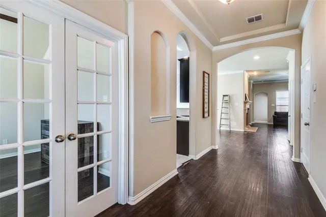 a view of a hallway with wooden floor and staircase