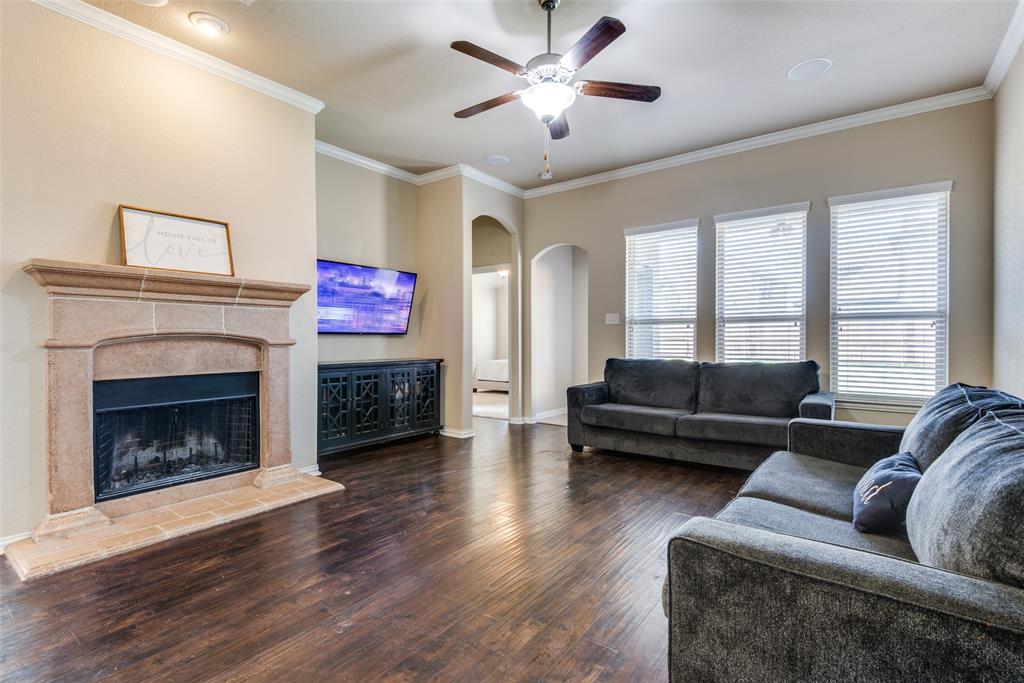 16621 Toledo Bend Court Prosper, TX 75078 - Photo 7 of 25 a living room with furniture and a fireplace