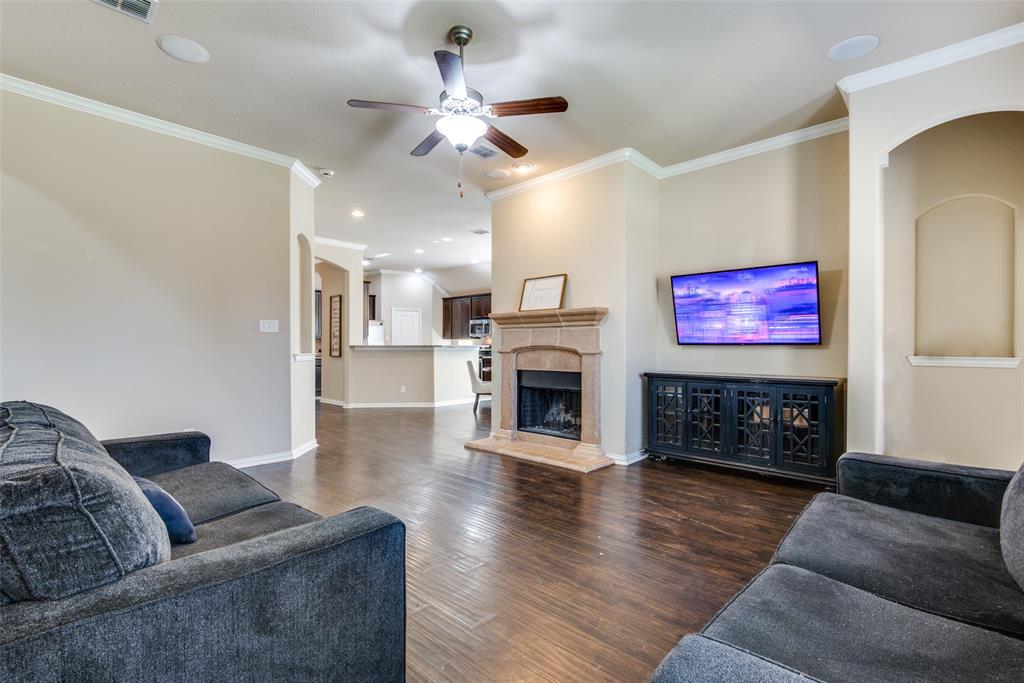 16621 Toledo Bend Court Prosper, TX 75078 - Photo 8 of 25 a living room with furniture a fireplace and wooden floor