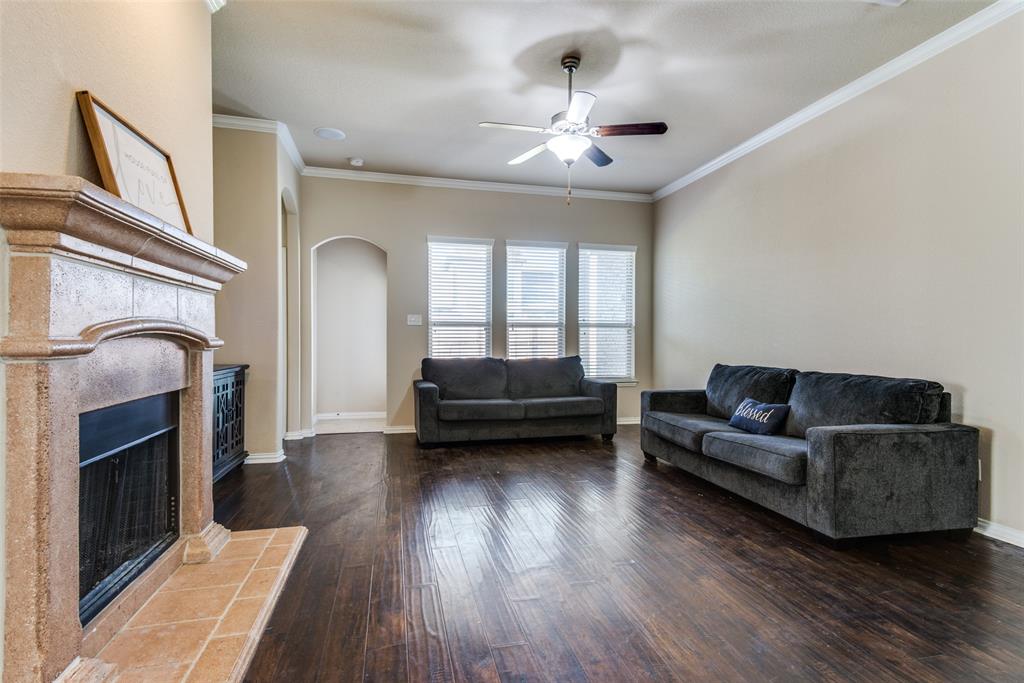 16621 Toledo Bend Court Prosper, TX 75078 - Photo 9 of 25 a living room with furniture and a fireplace