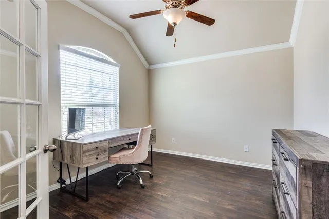 a view of a workspace with furniture and a window