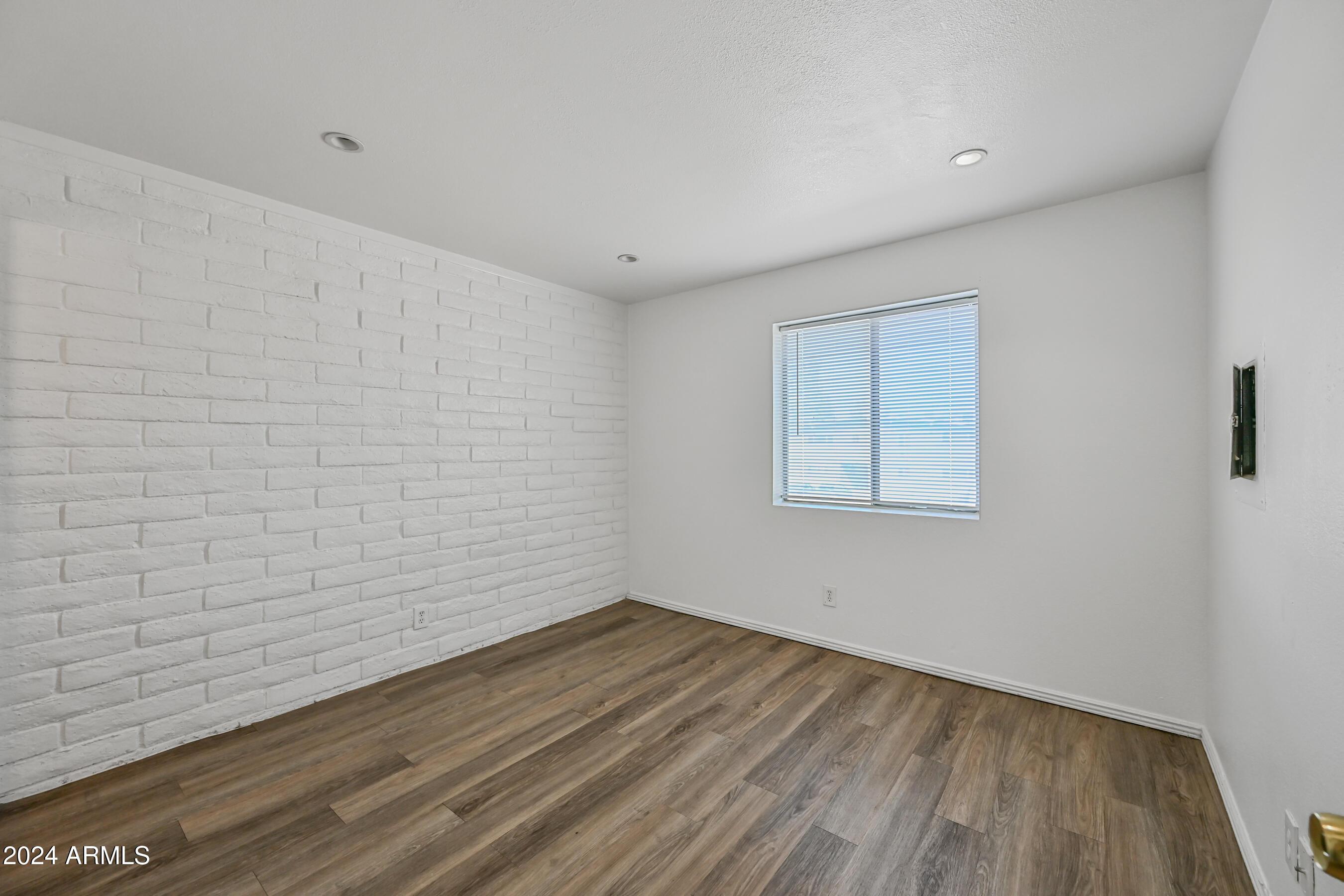1234 North 36th Street, Unit 209 Phoenix, AZ 85008 - Photo 12 of 15 a view of a room with wooden floor and white walls