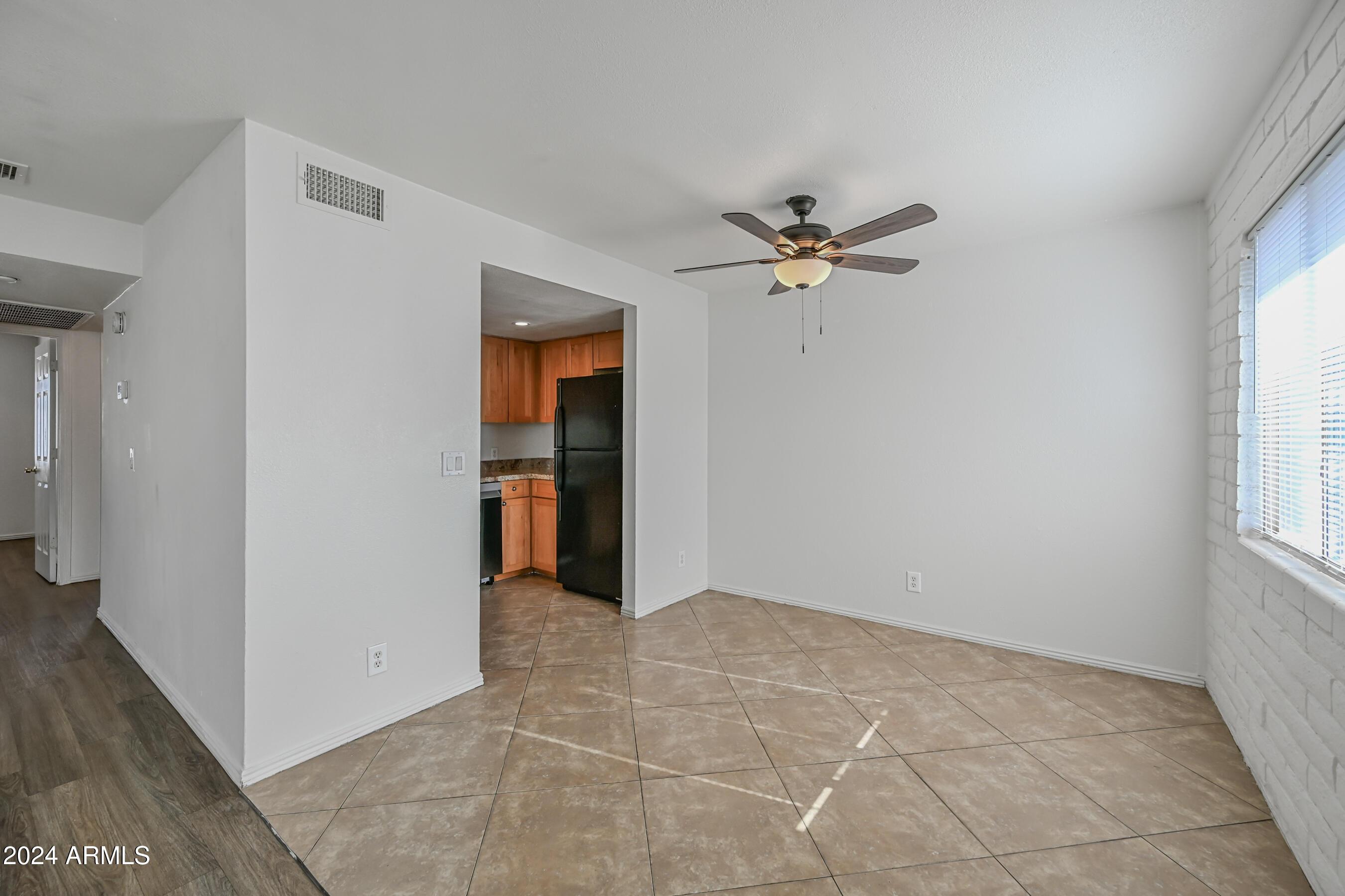 1234 North 36th Street, Unit 209 Phoenix, AZ 85008 - Photo 7 of 15 an empty room with fan and windows