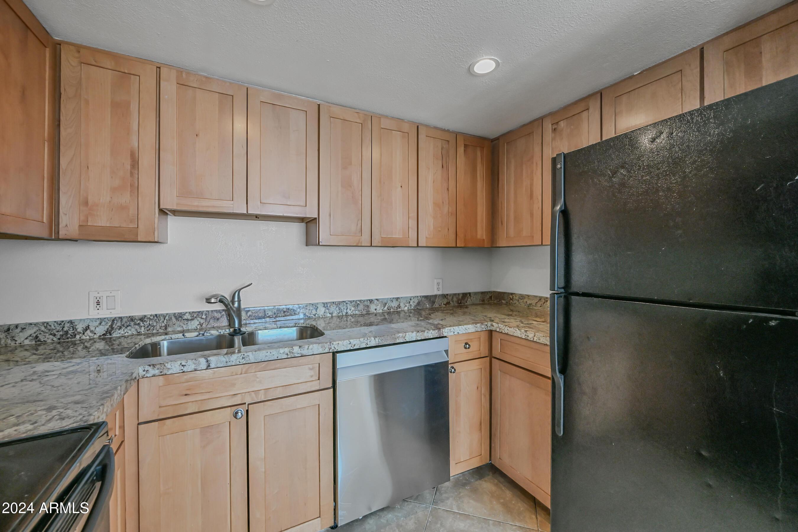 1234 North 36th Street, Unit 209 Phoenix, AZ 85008 - Photo 9 of 15 a kitchen with stainless steel appliances granite countertop white refrigerator stove a sink and dishwasher