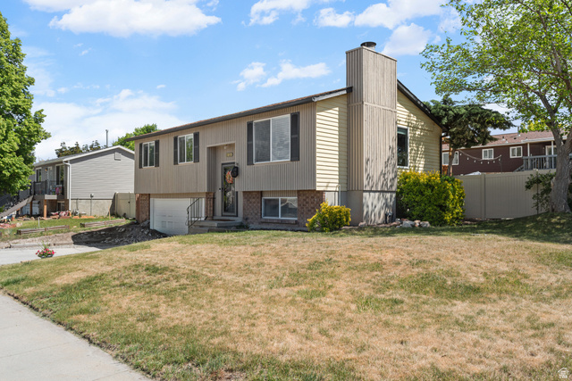 3951 Brixton Road Salt Lake City, UT 84129 - Photo 3 of 22 Split-level residence featuring a two-tone facade with horizontal siding and brick accents