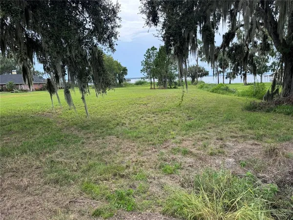 a view of outdoor space with green field and trees