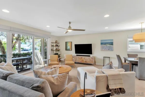 a living room with furniture a rug and a flat screen tv