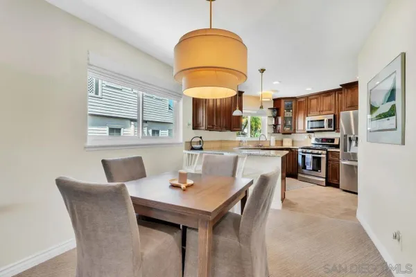 a kitchen with stainless steel appliances granite countertop a refrigerator sink and stove