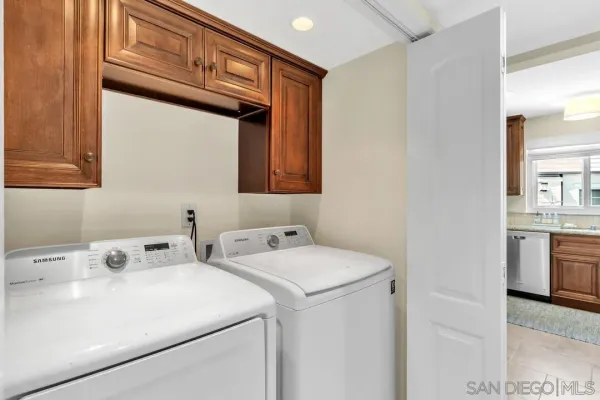 a bedroom with a large bed and a flat tv screen on dresser