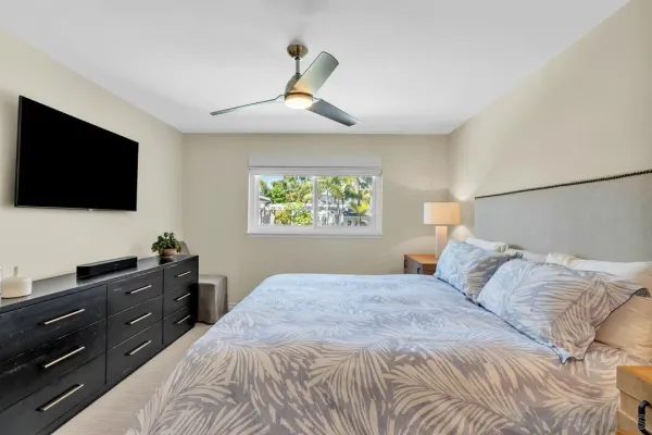 a bathroom with a granite countertop sink a mirror and shower
