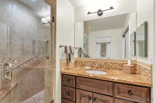 a bedroom with furniture and a large window