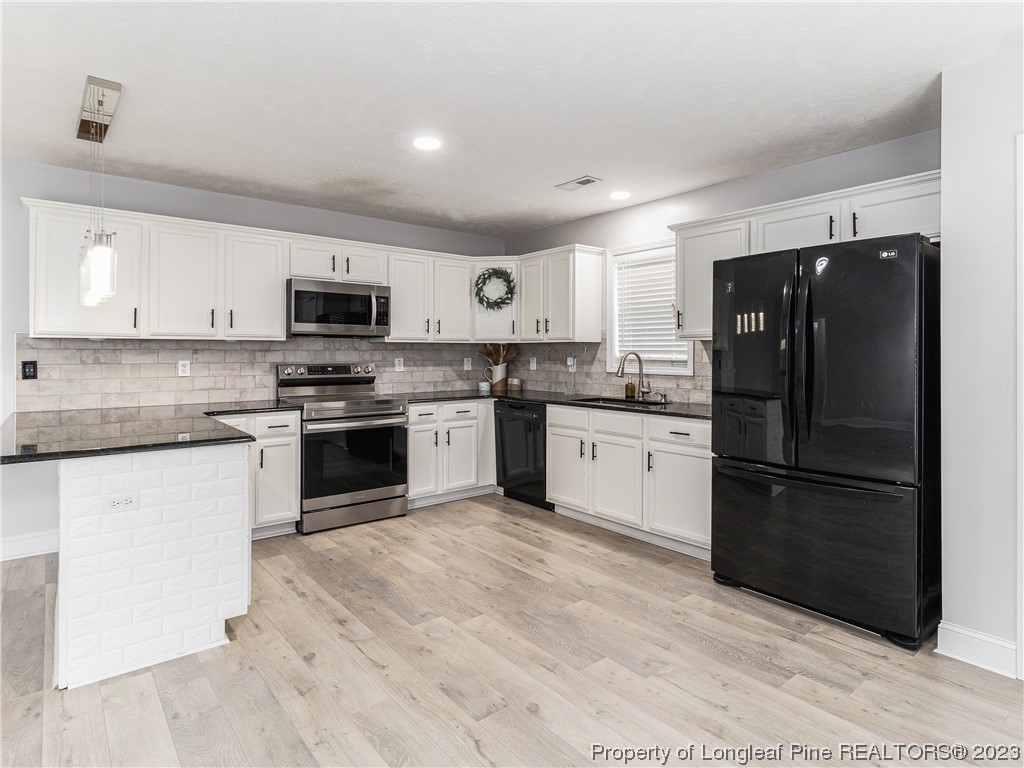 1964 Yellowbrick Road Fayetteville, NC 28314 - Photo 13 of 37 a kitchen with a refrigerator stove top oven and sink