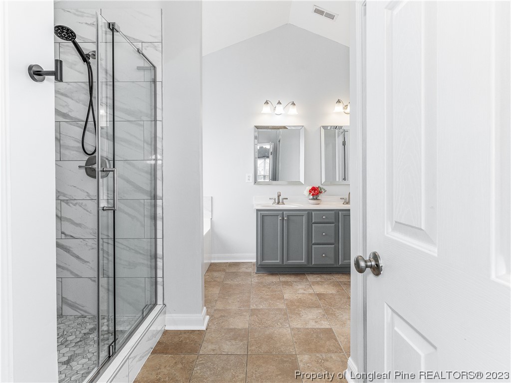 1964 Yellowbrick Road Fayetteville, NC 28314 - Photo 18 of 37 a bathroom with a tub sink mirror and shower