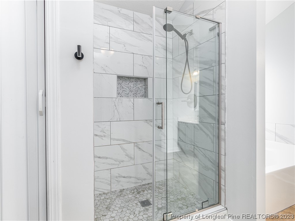 1964 Yellowbrick Road Fayetteville, NC 28314 - Photo 19 of 37 a bathroom with a glass shower door