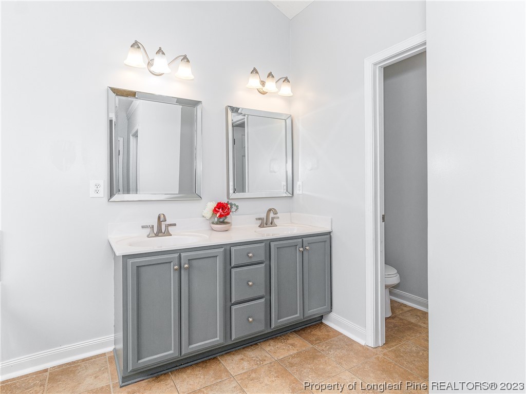 1964 Yellowbrick Road Fayetteville, NC 28314 - Photo 21 of 37 a bathroom with a sink and a mirror