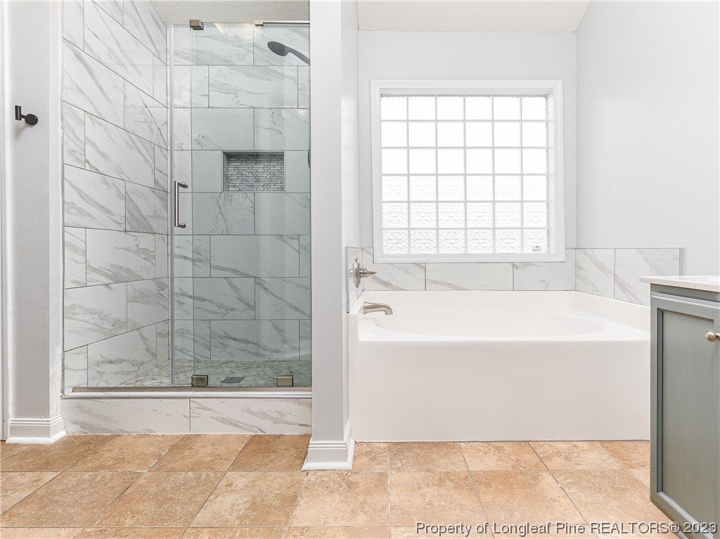 1964 Yellowbrick Road Fayetteville, NC 28314 - Photo 22 of 37 a bathroom with a bathtub and shower